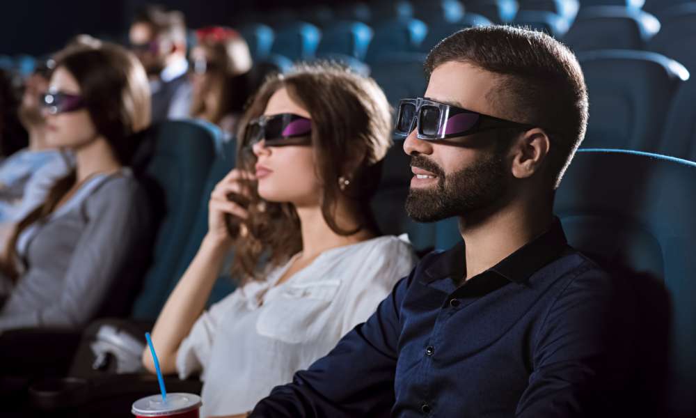 Young happy couple having a date at the cinema