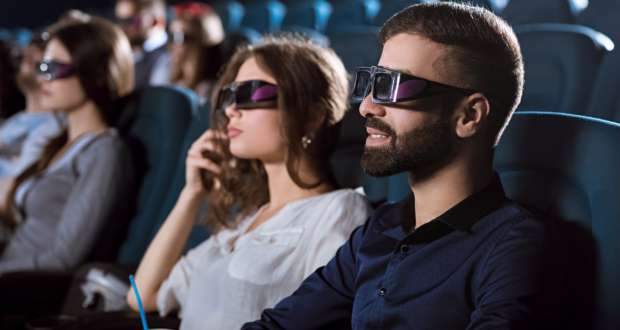 Young happy couple having a date at the cinema